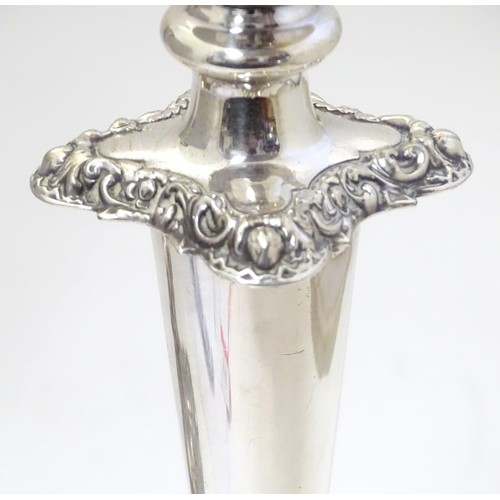 942 - A pair of silver plate candlesticks with acanthus scroll and floral decoration Approx 12