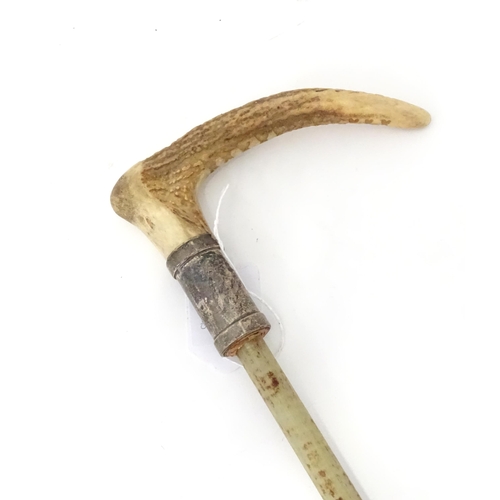 944 - A mid 20thC riding crop mount, with antler handle, silver collar and fibreglass core. Approx 20 1/4