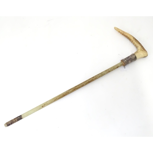 944 - A mid 20thC riding crop mount, with antler handle, silver collar and fibreglass core. Approx 20 1/4