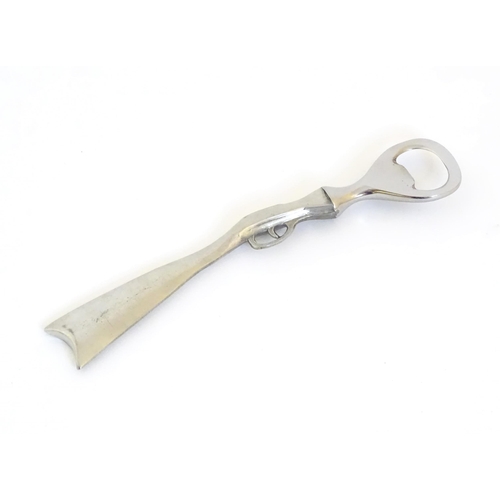 948 - A boxed silver plated bottle opener, the handle formed as a the stock and action of a shotgun, appro... 