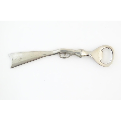 948 - A boxed silver plated bottle opener, the handle formed as a the stock and action of a shotgun, appro... 