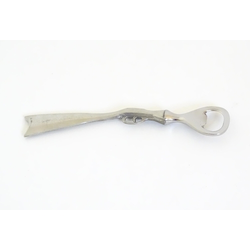 948 - A boxed silver plated bottle opener, the handle formed as a the stock and action of a shotgun, appro... 