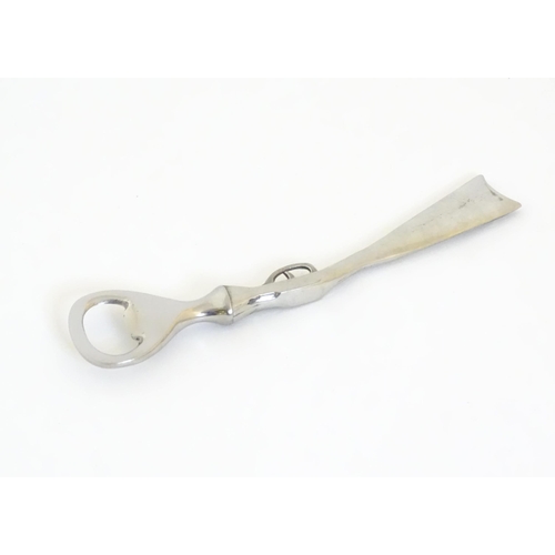 948 - A boxed silver plated bottle opener, the handle formed as a the stock and action of a shotgun, appro... 