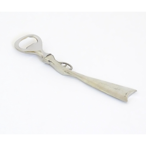 948 - A boxed silver plated bottle opener, the handle formed as a the stock and action of a shotgun, appro... 