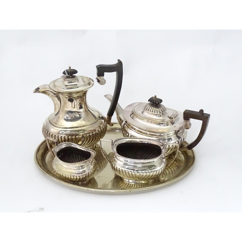 963 - A 4-piece silver plate tea set. Together with an oval silver plated tray. The tray 16