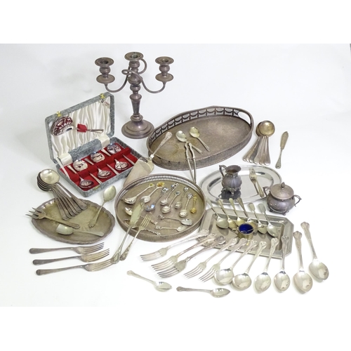 950 - A quantity of assorted silver plated wares to include various trays, flatware, candelabra, milk jug,... 