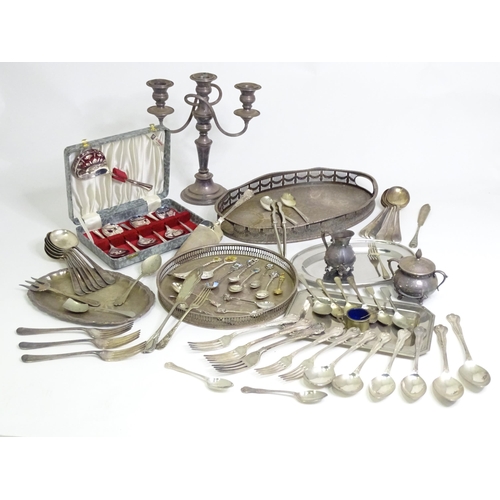 950 - A quantity of assorted silver plated wares to include various trays, flatware, candelabra, milk jug,... 