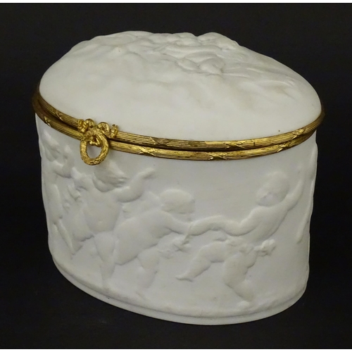 71 - A Limoges parian ware oval box with a hinged lid, decorated in relief with dancing putti / cherubs. ... 