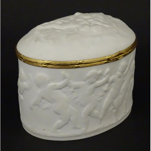 71 - A Limoges parian ware oval box with a hinged lid, decorated in relief with dancing putti / cherubs. ... 