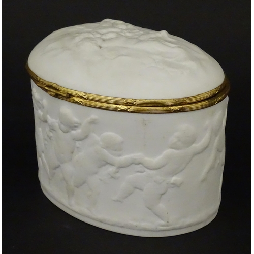 71 - A Limoges parian ware oval box with a hinged lid, decorated in relief with dancing putti / cherubs. ... 