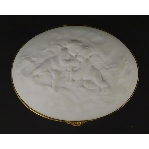 71 - A Limoges parian ware oval box with a hinged lid, decorated in relief with dancing putti / cherubs. ... 