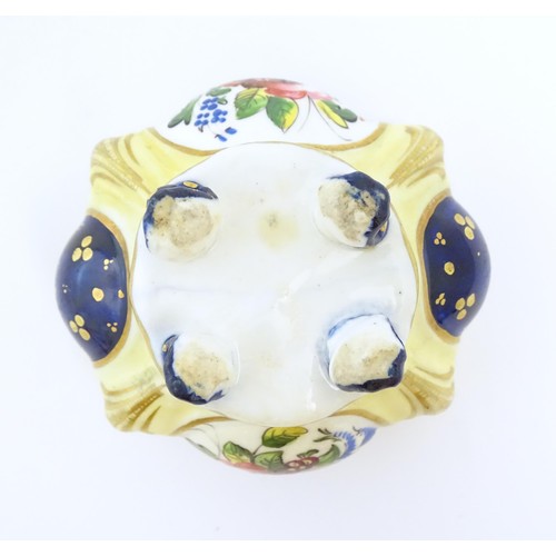 73 - A Continental porcelain inkwell of shaped form with floral and foliate detail and gilt highlights. A... 