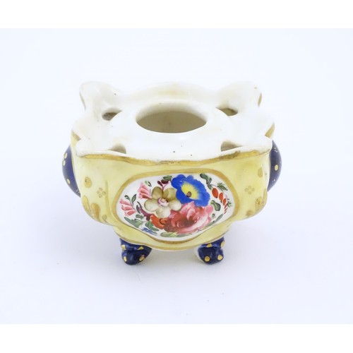 73 - A Continental porcelain inkwell of shaped form with floral and foliate detail and gilt highlights. A... 