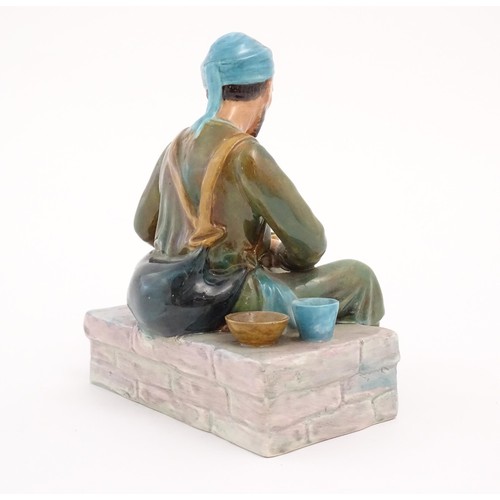 112 - A studio pottery figure modelled as an Egyptian Water Carrier, by Reg Johnson. Signed and titled to ... 