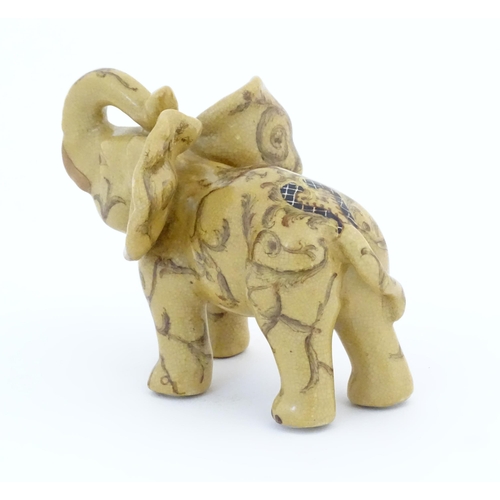 74 - An Oriental ceramic model of an elephant with painted detail. Marked under. Approx. 7