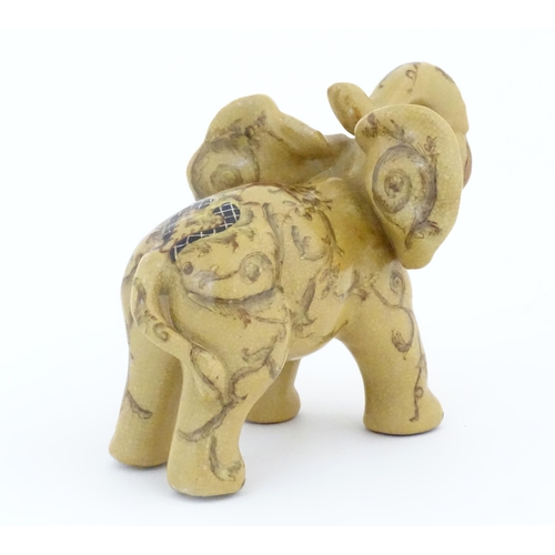 74 - An Oriental ceramic model of an elephant with painted detail. Marked under. Approx. 7