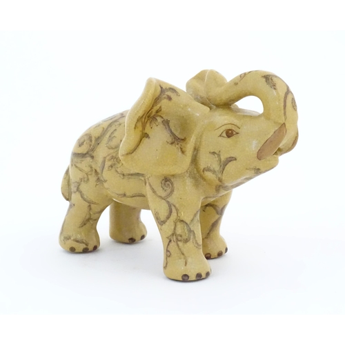 74 - An Oriental ceramic model of an elephant with painted detail. Marked under. Approx. 7