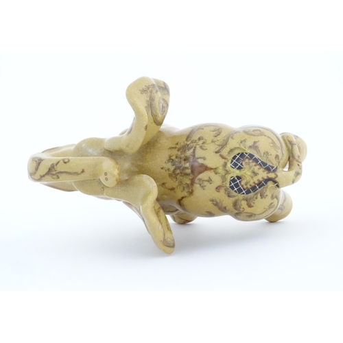 74 - An Oriental ceramic model of an elephant with painted detail. Marked under. Approx. 7