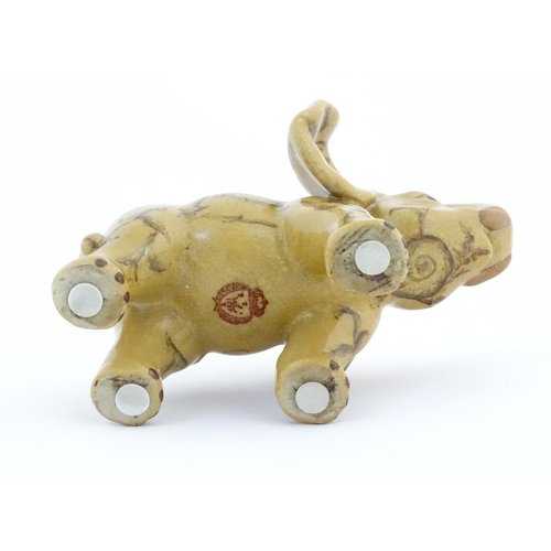 74 - An Oriental ceramic model of an elephant with painted detail. Marked under. Approx. 7