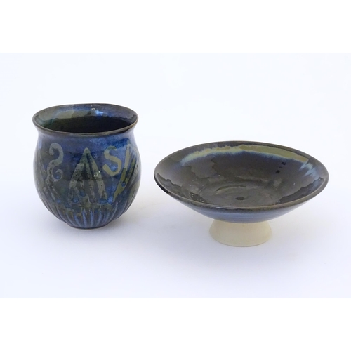 76 - Two items of studio pottery comprising a footed bowl of tapering form with a blue glaze, incised LW ... 