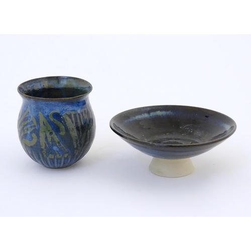 76 - Two items of studio pottery comprising a footed bowl of tapering form with a blue glaze, incised LW ... 