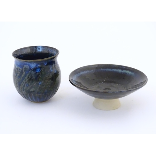 76 - Two items of studio pottery comprising a footed bowl of tapering form with a blue glaze, incised LW ... 