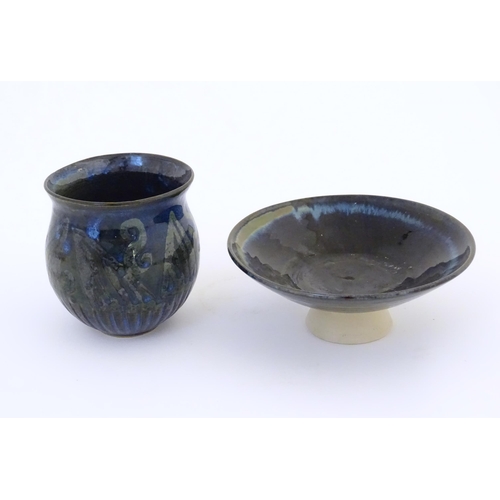 76 - Two items of studio pottery comprising a footed bowl of tapering form with a blue glaze, incised LW ... 