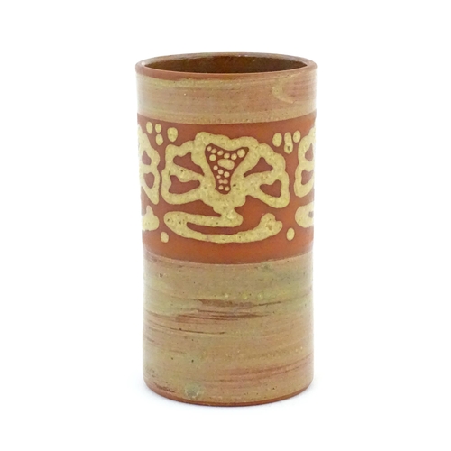 78 - A terracotta studio pottery vase of cylindrical form with banded slip decoration. Signed under. Appr... 