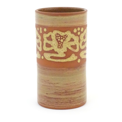 78 - A terracotta studio pottery vase of cylindrical form with banded slip decoration. Signed under. Appr... 