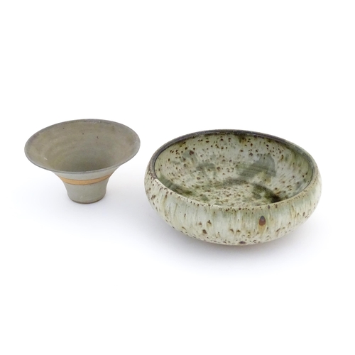 80 - Two items of studio pottery comprising a large shallow bowl with a speckled glaze, indistinctly sign... 