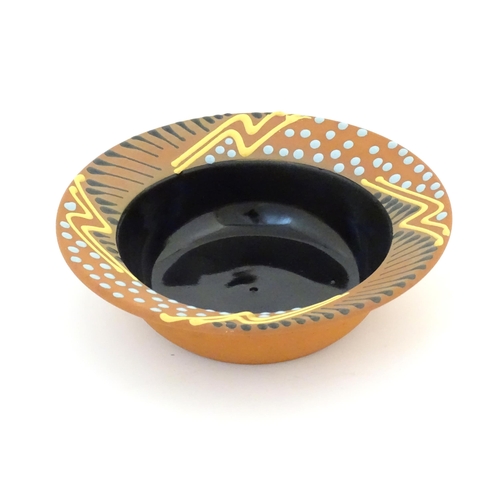 82 - An Australian studio pottery terracotta bowl by John Clift (b. 1954) with slip detail to rim. Signed... 