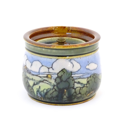 103 - A Royal Doulton stoneware tobacco jar with landscape decoration. Marked under with maker's mark DJ, ... 