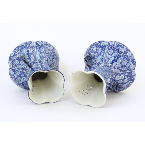 97 - A pair of Continental blue and white twin handled vases with floral / blossom decoration, the neck w... 