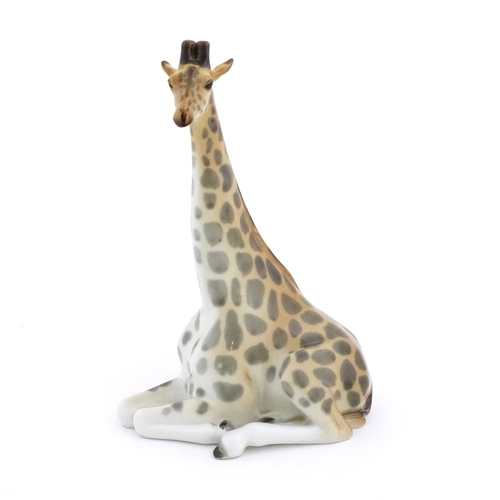 110 - A Russian Lomonosov pottery model of a seated giraffe. Marked under. Approx. 11 3/4