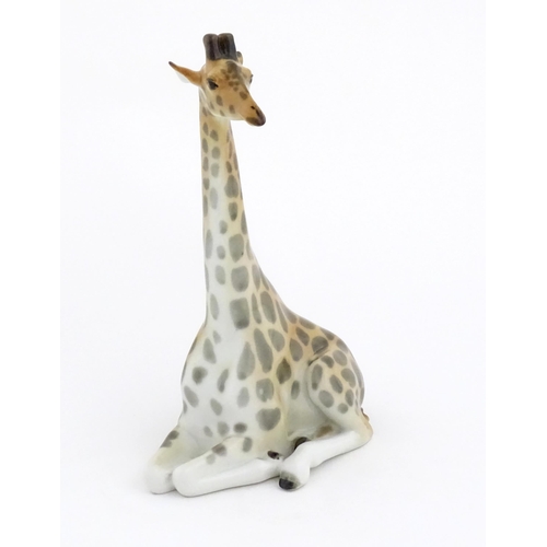 110 - A Russian Lomonosov pottery model of a seated giraffe. Marked under. Approx. 11 3/4