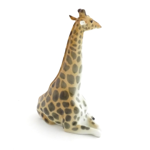 110 - A Russian Lomonosov pottery model of a seated giraffe. Marked under. Approx. 11 3/4