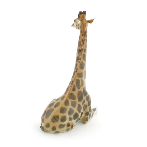 110 - A Russian Lomonosov pottery model of a seated giraffe. Marked under. Approx. 11 3/4