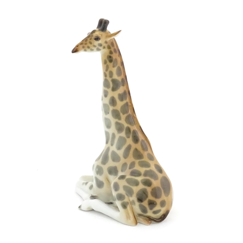 110 - A Russian Lomonosov pottery model of a seated giraffe. Marked under. Approx. 11 3/4