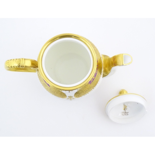 115 - A De Lamerie Fine Bone China teapot in the pattern Royal Bow with gilt highlights. Marked under. Wit... 