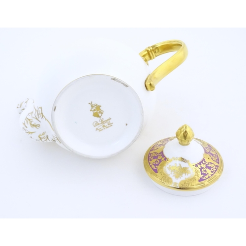 115 - A De Lamerie Fine Bone China teapot in the pattern Royal Bow with gilt highlights. Marked under. Wit... 