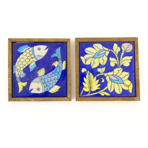 119 - Two Continental tiles with a cobalt blue ground, one decorated with two fish, the other with foliate... 