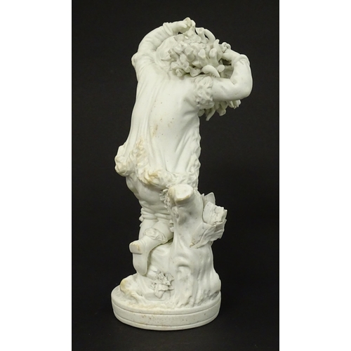 65 - A Derby bisque porcelain figure from The Seasons modelled as Autumn, a boy holding crops on a natura... 