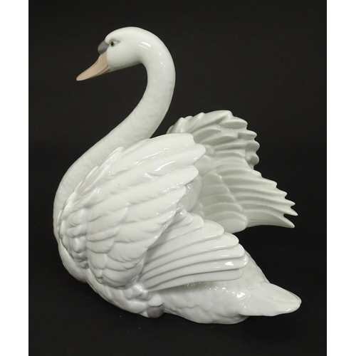 99 - A Lladro model of a swan, model no. 5231. Marked under. Approx. 7