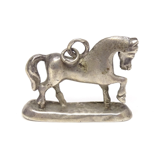 667 - A silver fob / pendant charm modelled as a horse. Approx 3/4