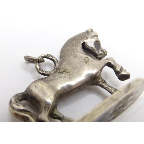 667 - A silver fob / pendant charm modelled as a horse. Approx 3/4