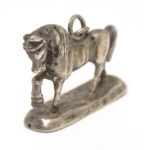 667 - A silver fob / pendant charm modelled as a horse. Approx 3/4