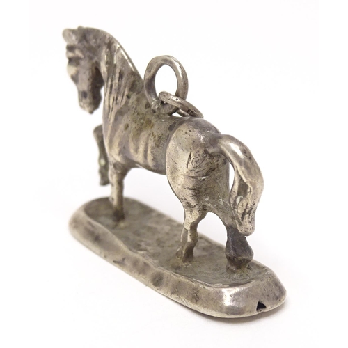 667 - A silver fob / pendant charm modelled as a horse. Approx 3/4