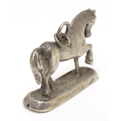 667 - A silver fob / pendant charm modelled as a horse. Approx 3/4