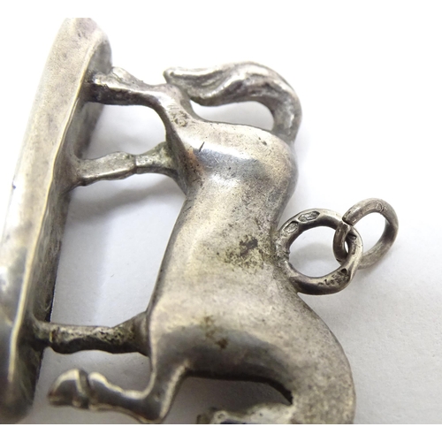 667 - A silver fob / pendant charm modelled as a horse. Approx 3/4