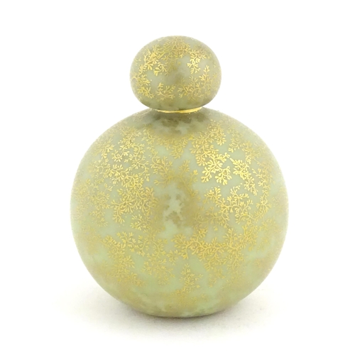 107 - A Royal Worcester scent bottle of globular form decorated with a turquoise ground and gilt foliate d... 